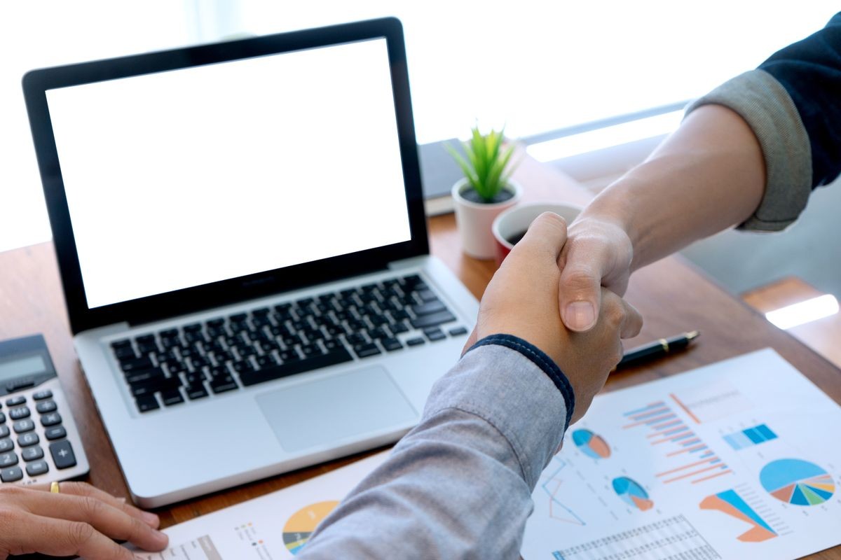 businessman work with friend on the table with computer laptop calulator ,working data analyses for business plan and marketing. with white computer screen with clipping path